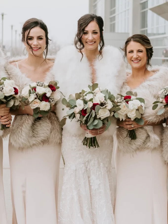bride wearing ivory faux fur shawl outdoor winter ceremony