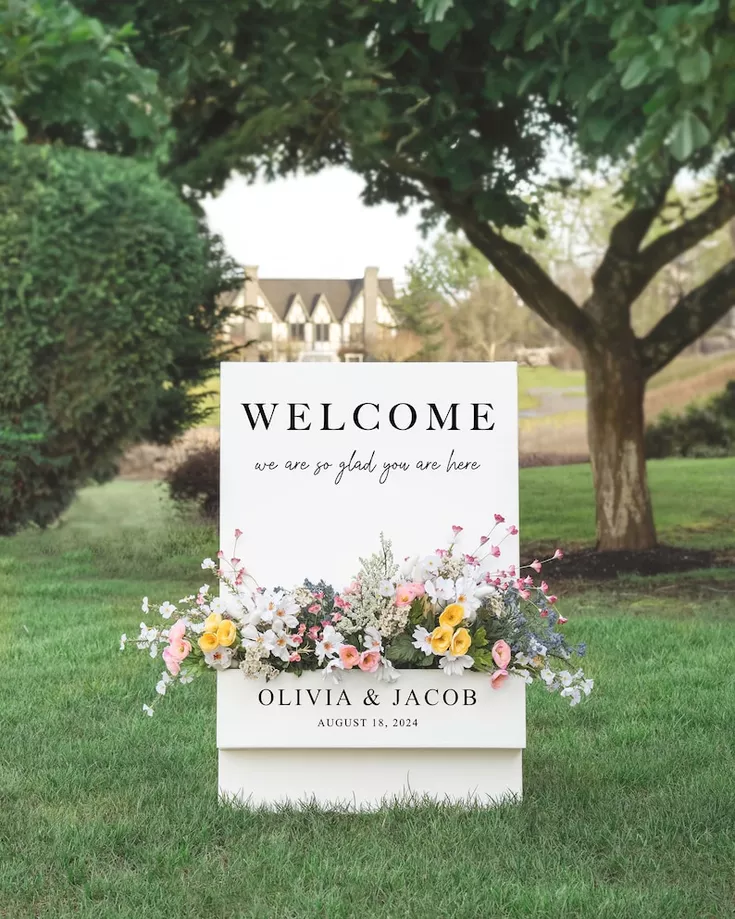 wedding welcome sign with flowers in a decorative flower box