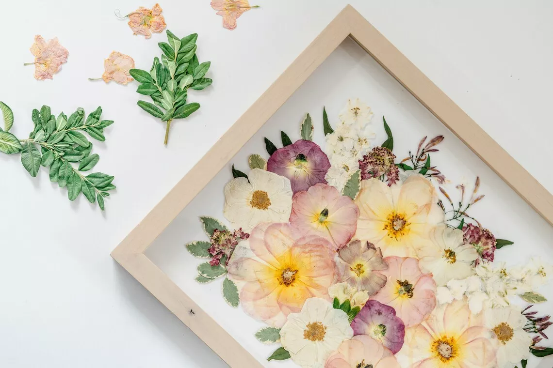 Pressed flowers preserved from a wedding bouquet in a frame