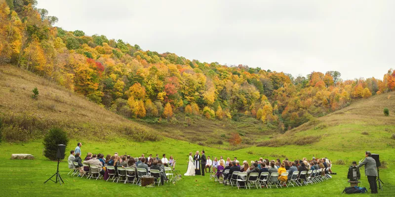 outdoor fall wedding ceremony with stunning foliage as natural decor