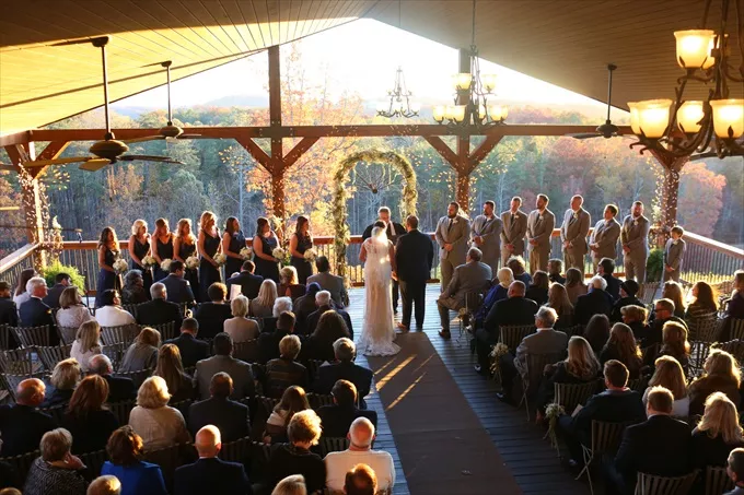 fall wedding ceremony decor idea with arch and stunning fall leaves in background