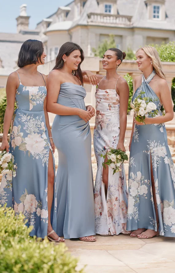 bridesmaids wearing shades of blue and floral bridesmaid dresses
