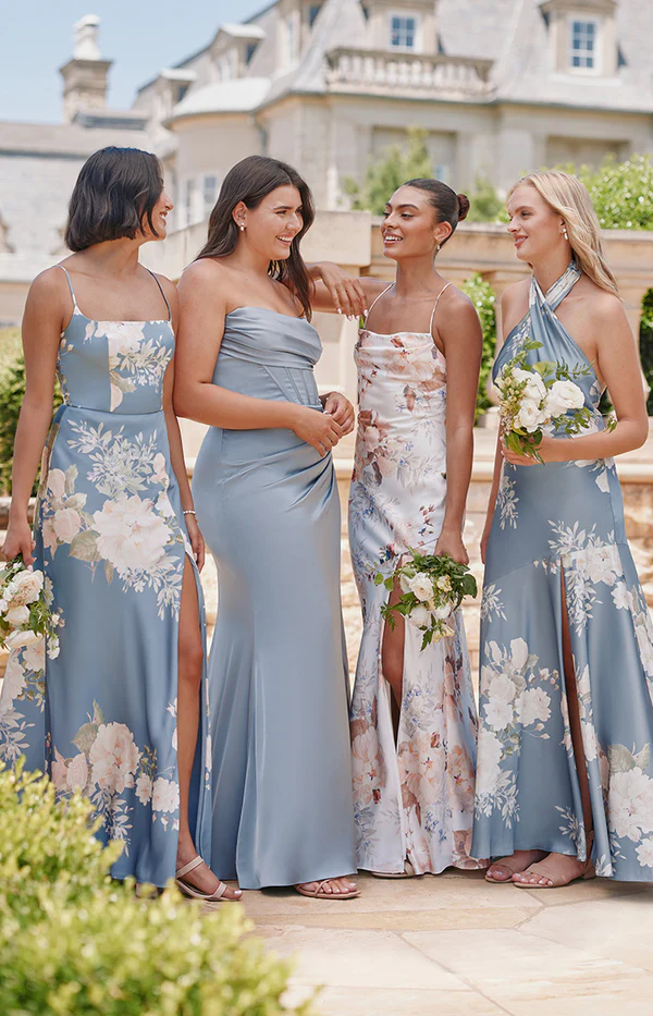 bridesmaids wearing shades of blue and floral bridesmaid dresses