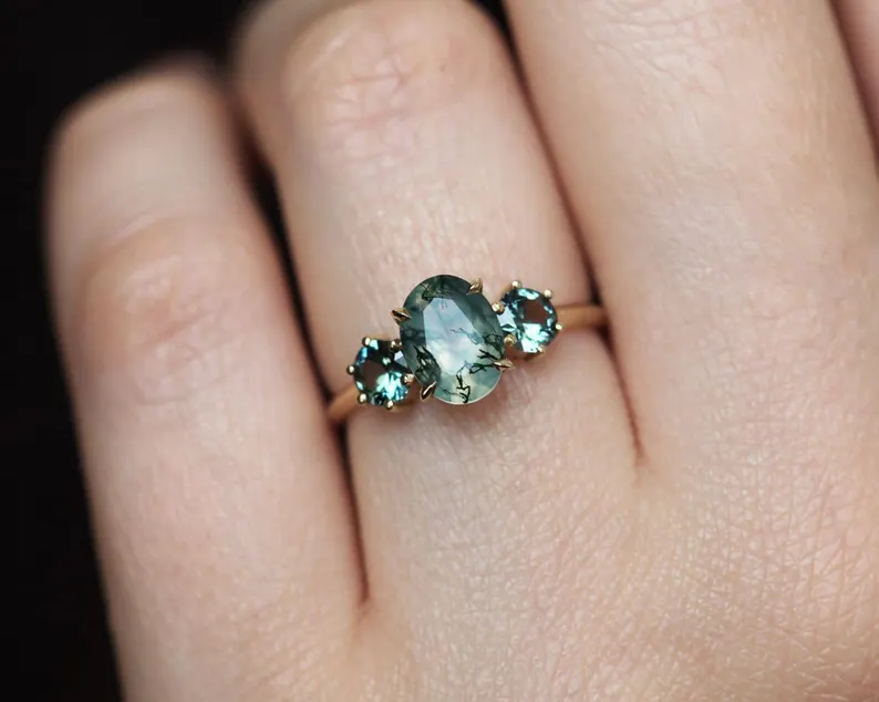 moss agate engagement ring worn on hand