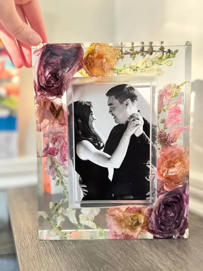 Wedding bouquet preserved in resin art block frame with roses and greenery