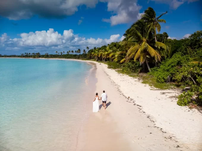 Bride and groom on the beach with blue water