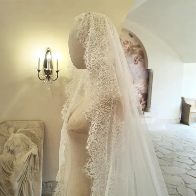 Chantilly lace bridal veil worn on mannequin