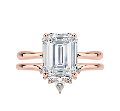 Wedding ring set with emerald cut diamond ring and matching curved diamond band in rose gold