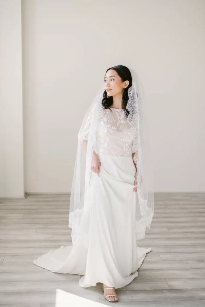 Bride wearing mantilla lace veil