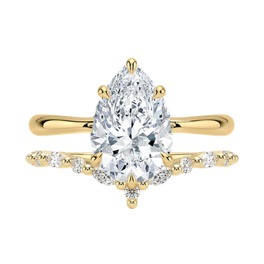 Pear shaped engagement ring paired with matching curved band