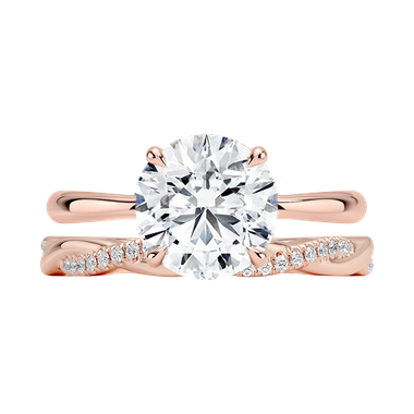 Petite vine wedding band with twisting style paired with round solitaire engagement ring