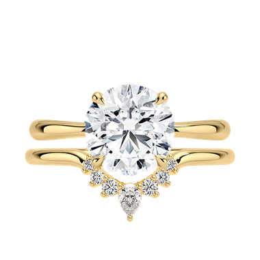 Round solitaire stone engagement ring paired with curved band