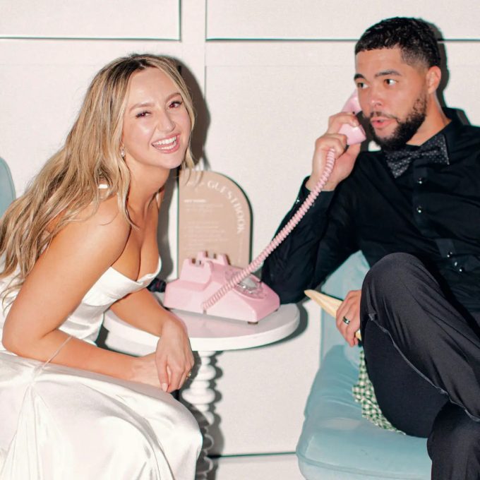 Bride laughing while guest leaving voice message on audio guest book