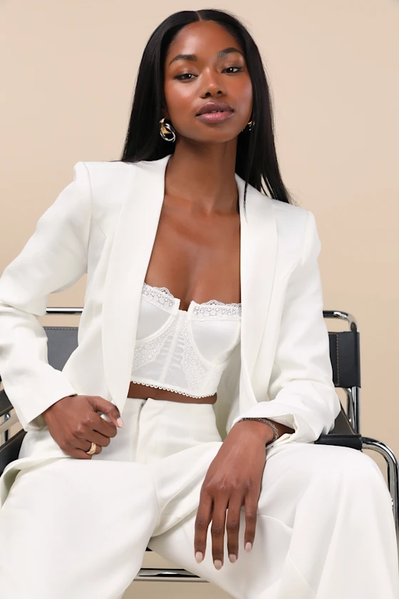 Bridal suit with white corset underneath and tailored wide-leg pants