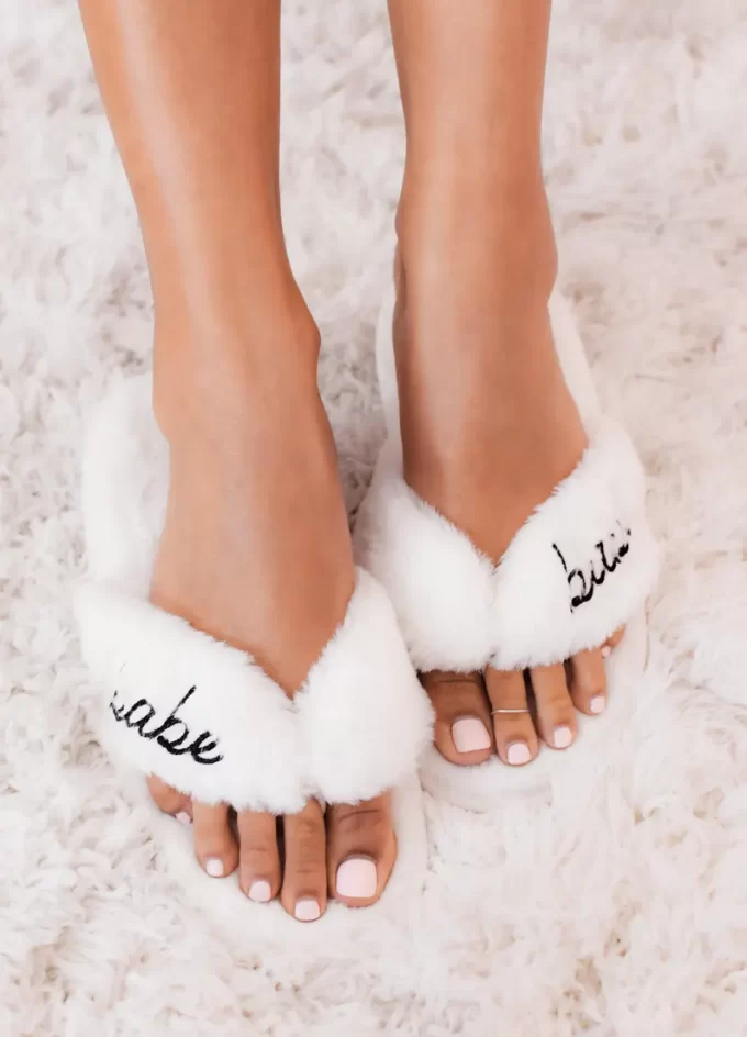 Fuzzy slippers for bridesmaids to wear on the wedding day