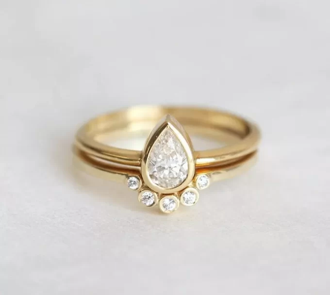 Half carat pear shaped engagement ring with unique simple band