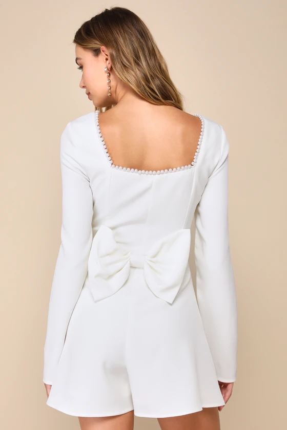 White romper with long sleeves and bow on the back
