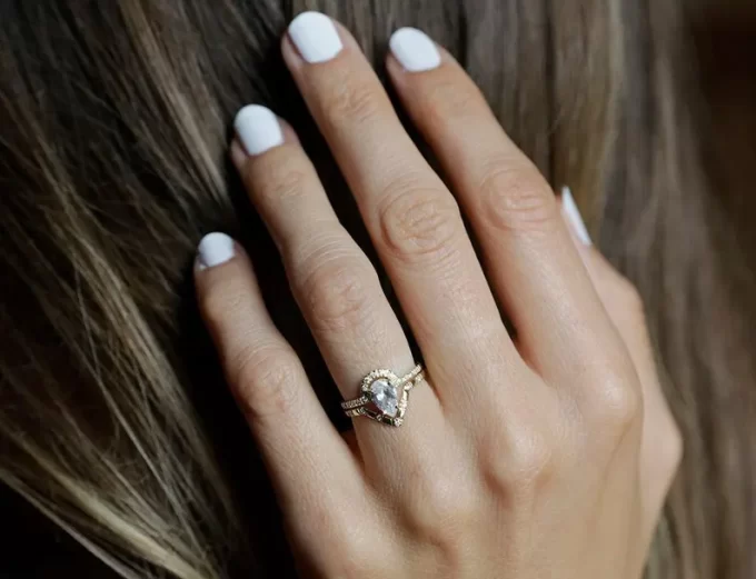Simple engagement ring worn on woman's finger
