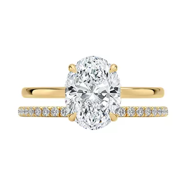 Oval engagement ring paired with half eternity band