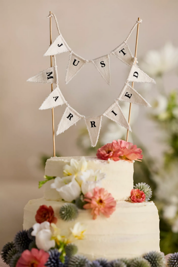 Pennant style wedding cake topper with Just Married writing on the flags
