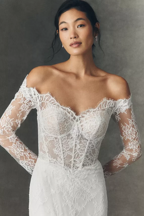 Lace corset style long sleeve wedding dress worn on bride