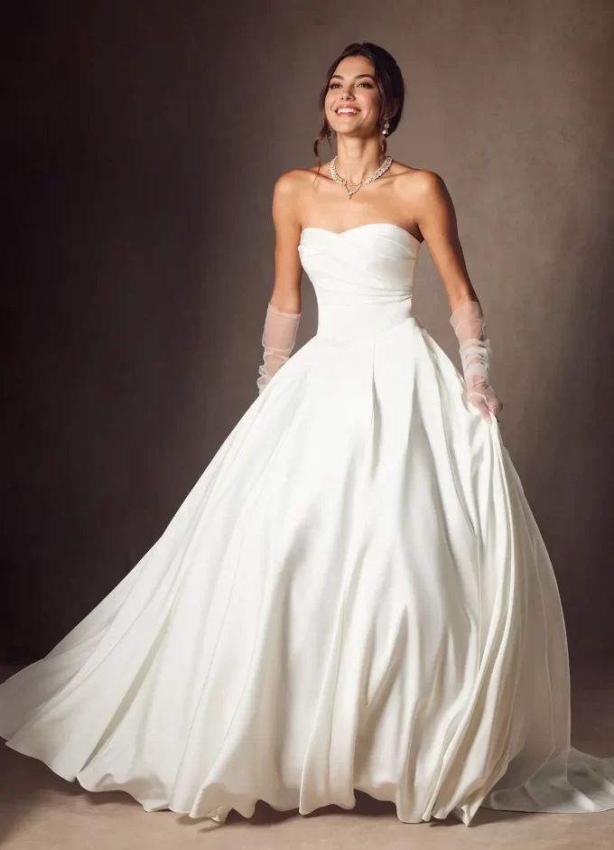 Bride wearing a stretch satin bridal gown with large skirt and gloves