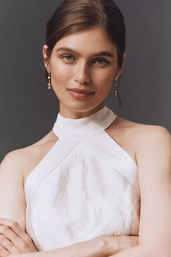 Bride wearing drop pearl earrings with a halter neckline wedding gown