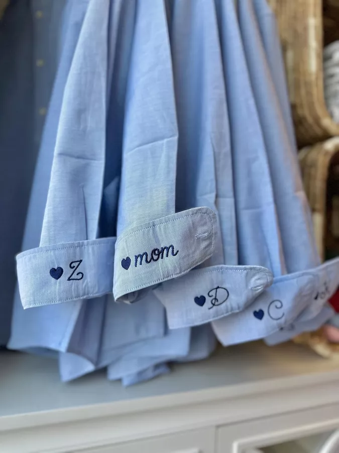 Bridesmaids wearing button-down shirts with tailored shorts while getting ready