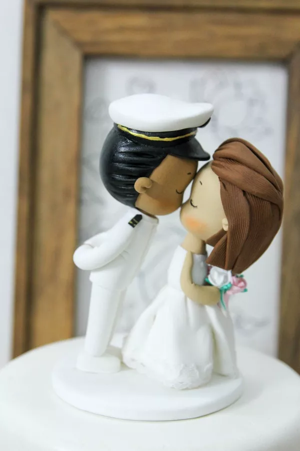 Custom military wedding cake topper featuring bride and groom figurines