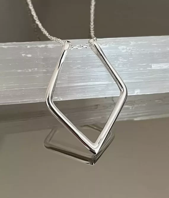 Geometric-style ring holder necklace keeping engagement ring
