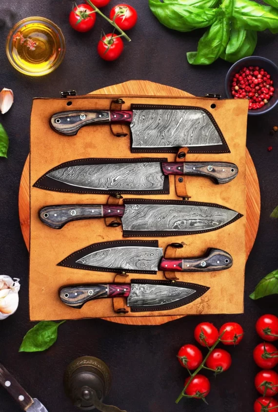 Hand forged set of damascus steel kitchen knives in tray