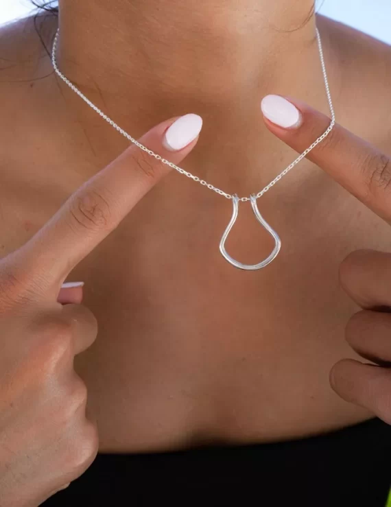 Horseshoe silver ring holder necklace showing holding engagement ring