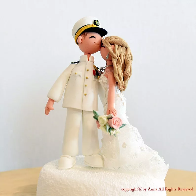 Navy wedding cake topper featuring couple and navy pilot in traditional military uniform