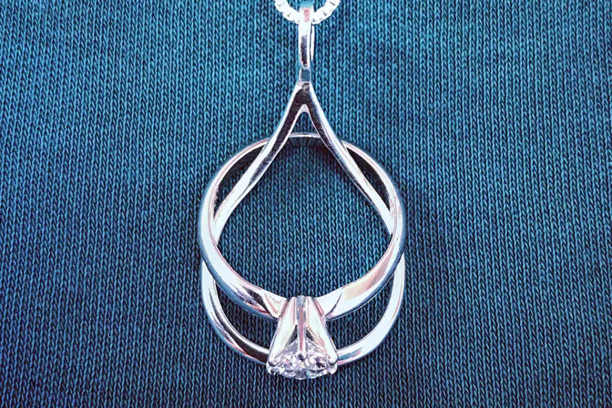 ring holder necklace holding an engagement and wedding ringee