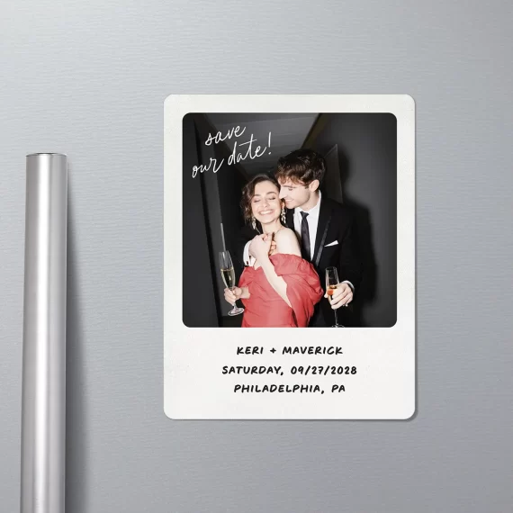 Polaroid-style save the date magnet on fridge with couple's photo