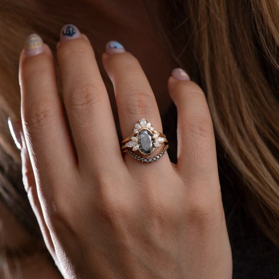 Black diamond engagement ring paired with curved black diamond wedding band