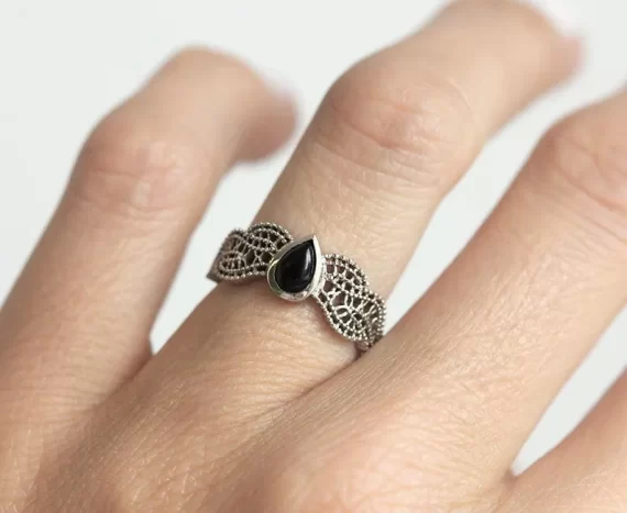 Black spinel engagement ring with ornate gold filigree detailing
