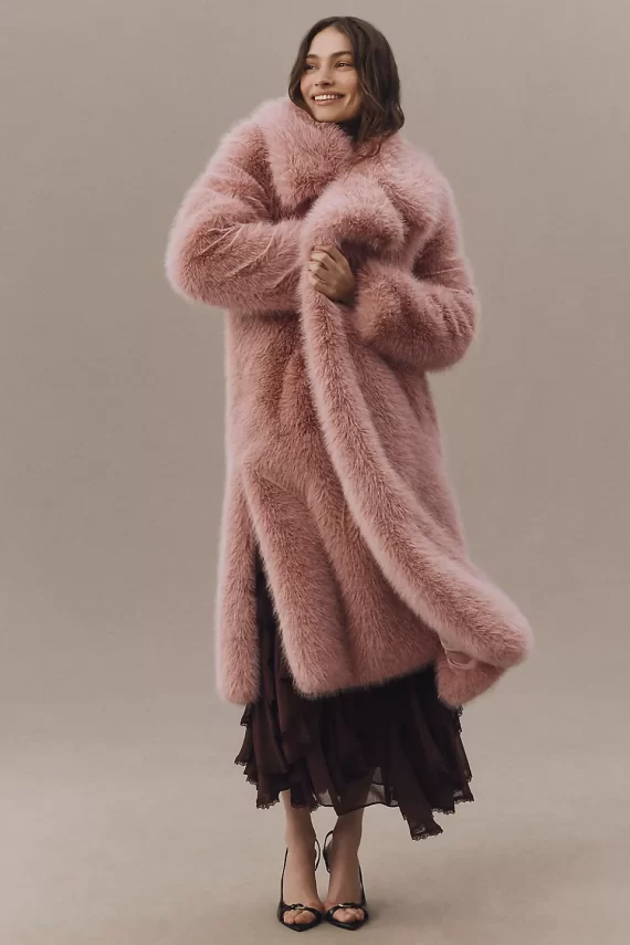 Blush colored long cozy winter wedding guest coat in faux fur
