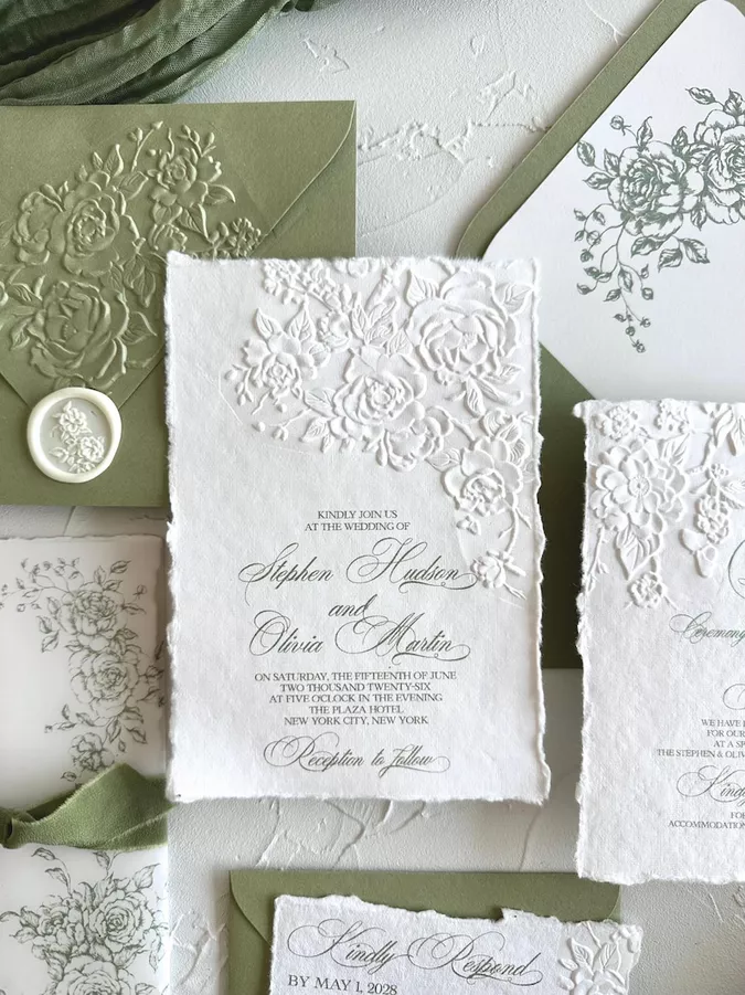 Embossed deckled edge wedding invitations with raised floral pattern
