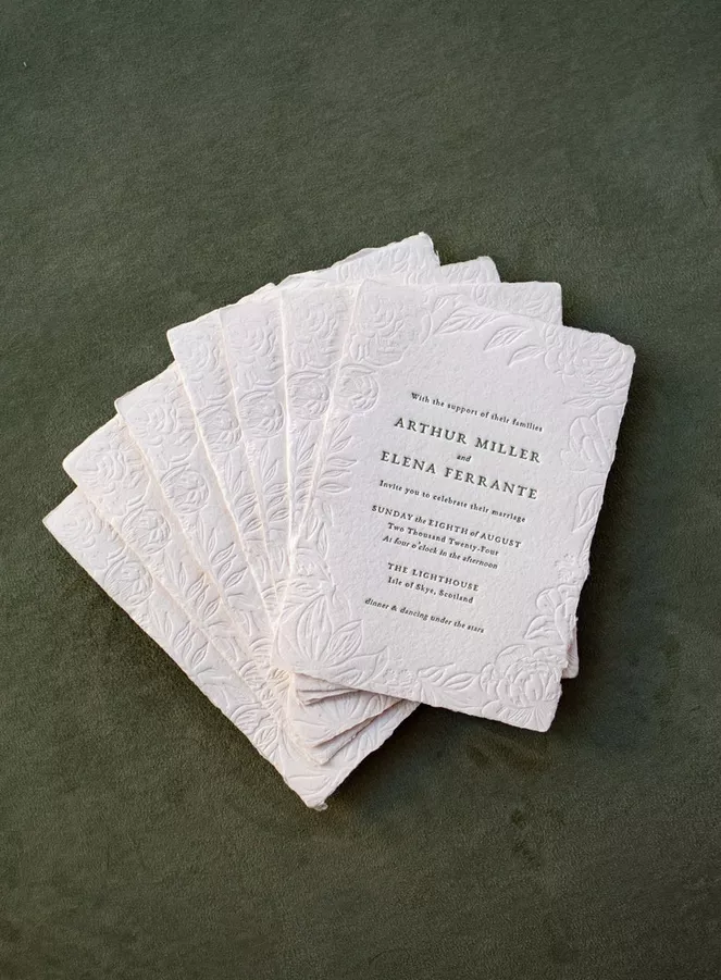 Elegant embossed wedding invitation with letterpress floral design
