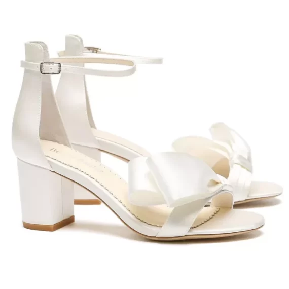 Low height heel of Bella Belle bridal shoes showing ankle strap and bow at toe