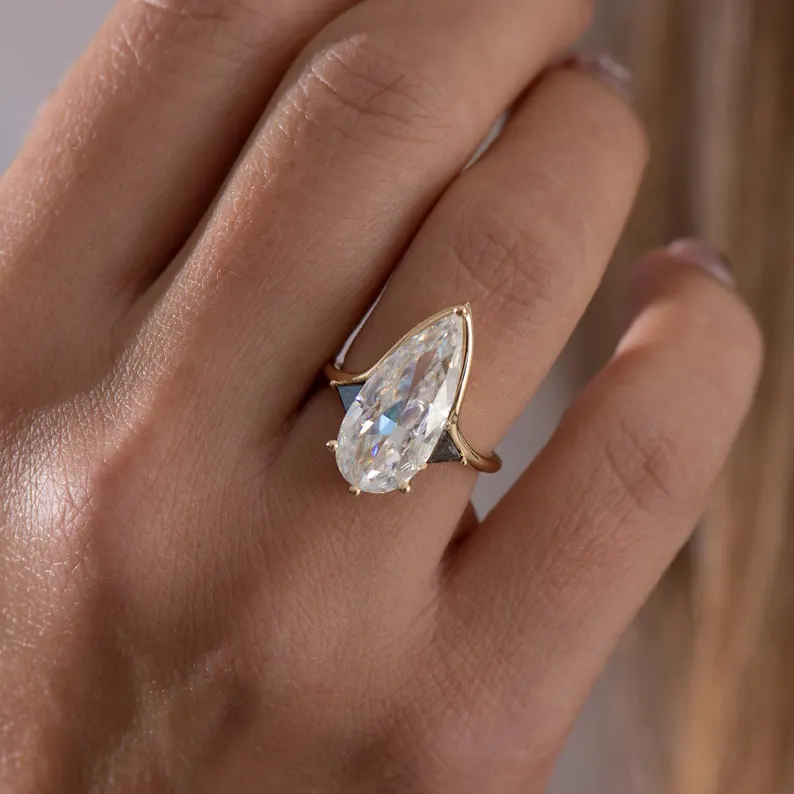 elongated pear shaped moissanite engagement ring