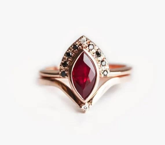 Ruby engagement ring featuring a marquise red gemstone and black diamond halo for a unique non-diamond engagement ring