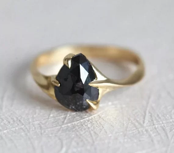 Pear shaped black diamond engagement ring with sleek gold band