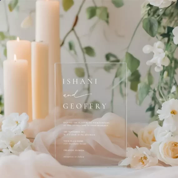 Real wedding table with acrylic wedding invitations and floral decor