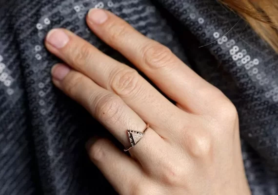 Triangle engagement ring with black diamond accents in modern design