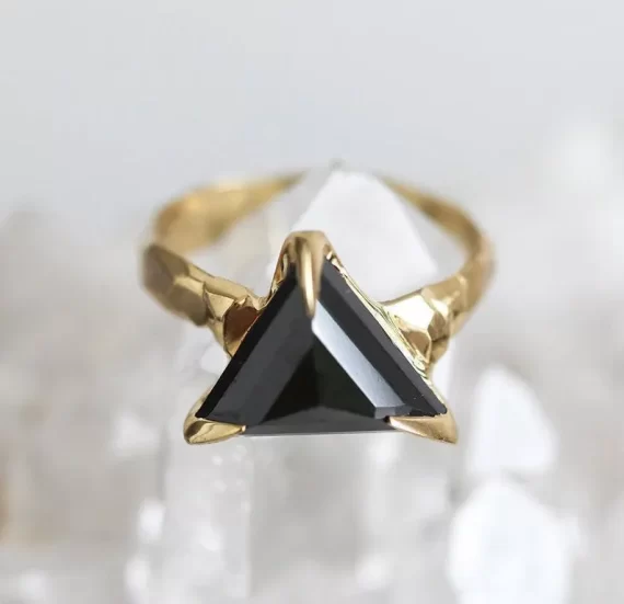 Trillion black diamond engagement ring with raw yellow gold setting