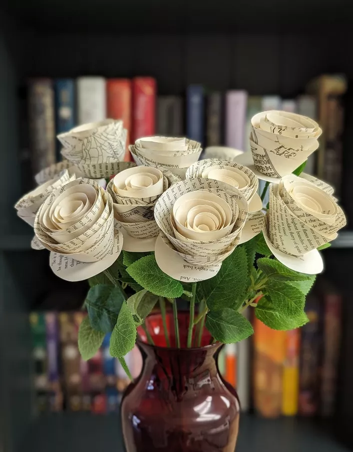 Handmade book page flowers used as wedding centerpieces without real flowers