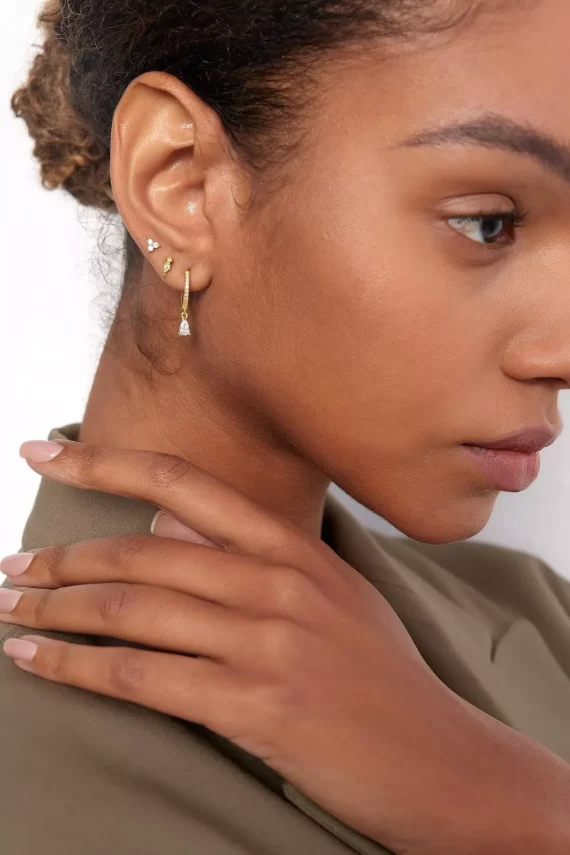 Bridesmaids wearing affordable jewelry that doesn’t tarnish, styled with neutral dresses