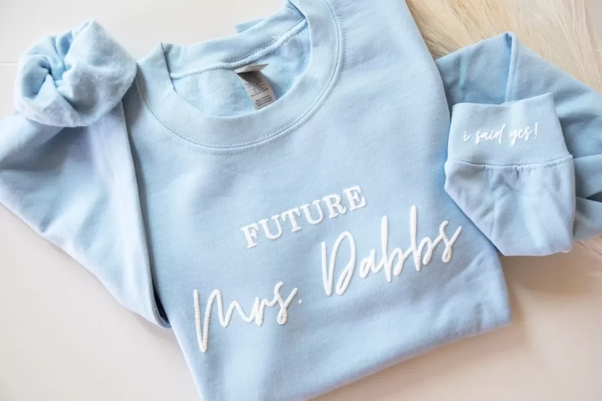 bride-to-be wearing a cozy future Mrs sweatshirt from Etsy